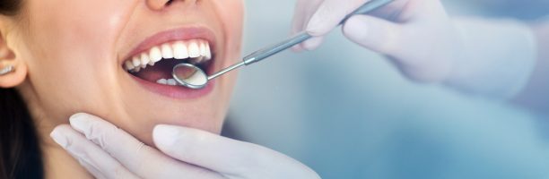 Woman having teeth examined at dentists